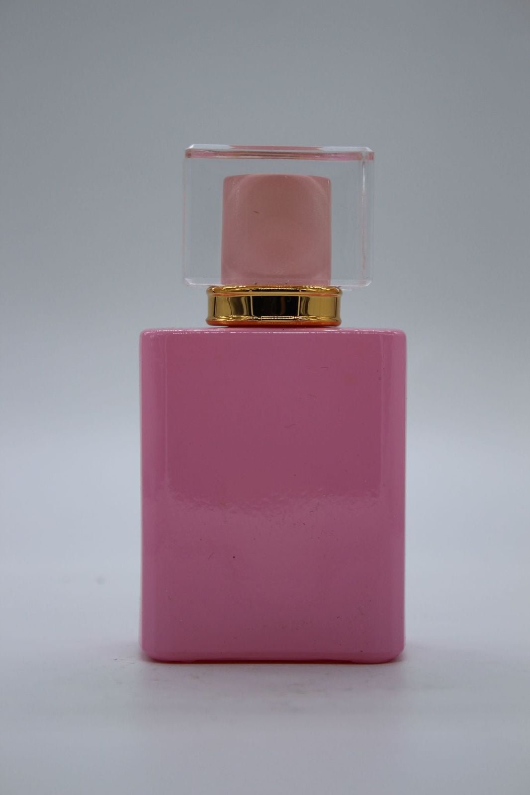 perfume in a pink square bottle